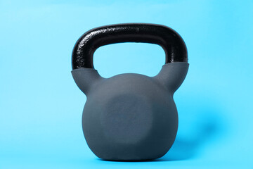One kettlebell on light blue background. Sport equipment
