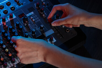 Woman working with professional mixing console at table, closeup