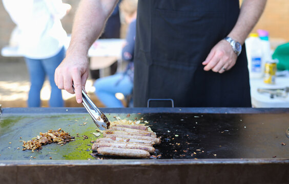 Sausages and onion cooking on a school fundraiser barbecue on election day