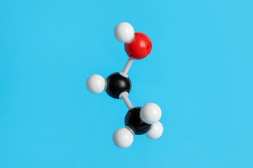 Molecule of ethanol on light blue background. Chemical model