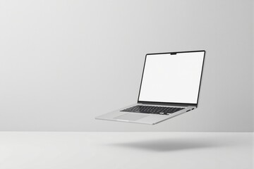 Floating laptop with blank screen on light background.