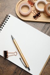 Different stationery on wooden table, flat lay