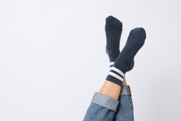 Woman wearing blue socks on white background, closeup. Space for text