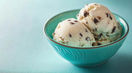 Delightful scoops of chocolate chip ice cream in teal bowl, refreshing and sweet treat