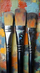 Fototapeta premium Paintbrushes on Colorful Palette, Studio Setting