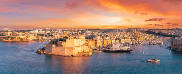 Landscape with Grand Harbour and Saint Angelo Fort at sunset time in Valletta, Malta.