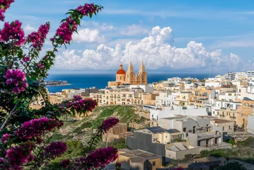 Fotobehang Mediterraans Europa Stunning coastal views and Mediterranean charm, with beauty of Mellieha Parish Church in Malta. Perfect for travel and architectural photography.  © Balate Dorin