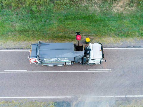 Aerial photo of garbage truck emptying bins in rural location