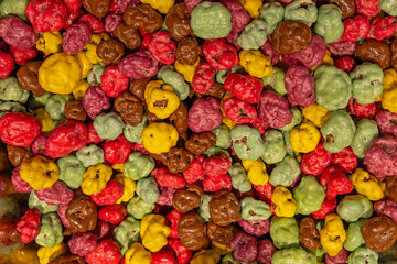 Colorful candy-coated popcorn close-up background.
