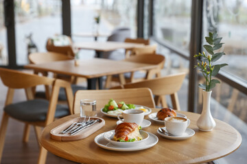 Delicious breakfast served on wooden table in cafe