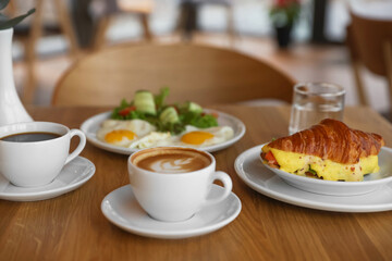 Delicious breakfast served on wooden table in cafe