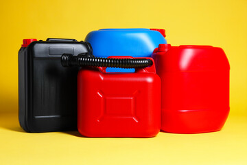 Many different plastic canisters on yellow background