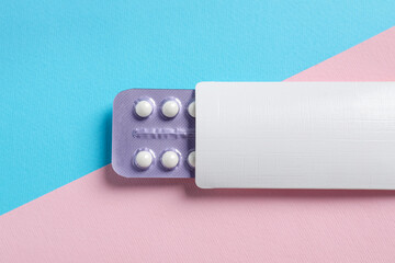 Blister of contraceptive pills in package on color background, top view. Mockup for design