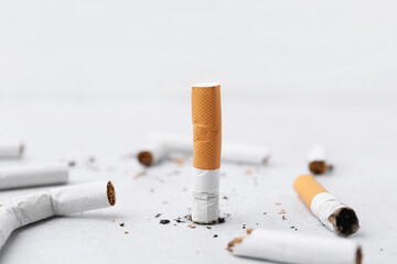 Many cigarette butts on light background. Smoking habit