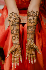 Close-up of intricate henna designs on hands, with palms facing up, showcasing beautiful