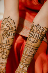 Close-up of intricate henna designs on hands, with palms facing up, showcasing beautiful