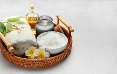 Magnesium flakes, essential oil, candle and towel creating relaxing spa atmosphere