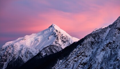 a snow covered mountain with a pink sky in the background