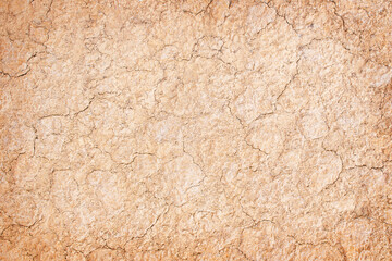 Texture of the dried earth with clay and sand, close-up or Brown dry soil or cracked ground texture background..