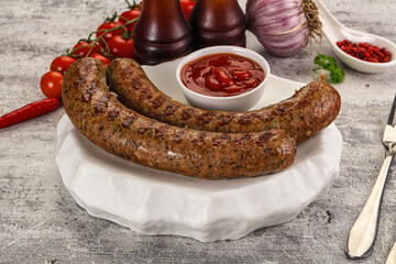 Grilled beef sausages with sauce