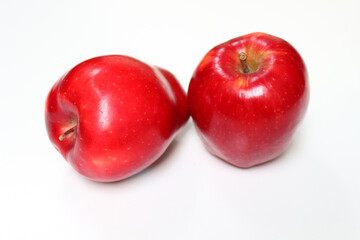 Close up of red apples on white background.
