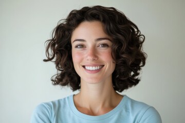 Woman smiles with curly brown hair