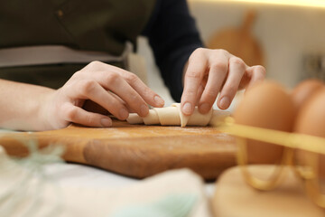 Obraz premium Woman making croissant at table indoors, closeup