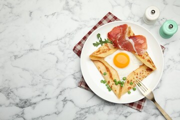 Delicious crepe with egg, bacon, arugula and green peas on white marble table, flat lay. Space for text