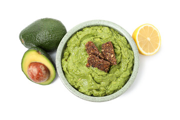 Tasty avocado dip in bowl, crispbreads and fruits isolated on white, top view