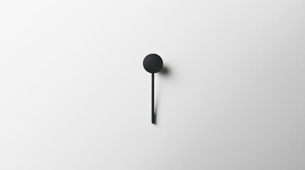 Minimalist black wall hook on white background