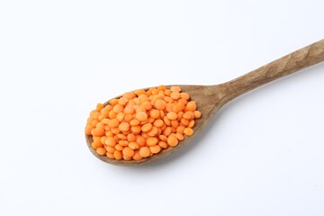 Raw lentils in wooden spoon isolated on white