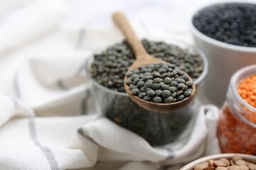 Different types of lentils on white table, closeup