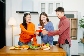 Young Asian friend having, enjoy evening party together at home. Attractive young man and woman...