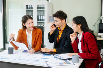 Office colleagues have a casual discussion. During a meeting in a conference room, a group of business teem