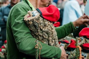 Man holding tio de nadal, traditional catalan christmas log, at christmas market