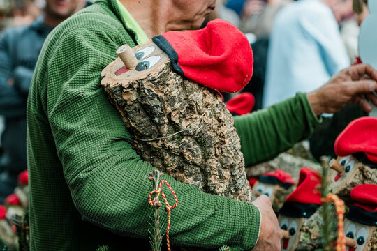 Man holding tio de nadal, traditional catalan christmas log, at christmas market
