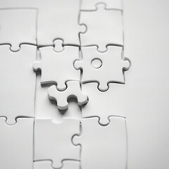 Obraz premium White jigsaw puzzle pieces almost complete.