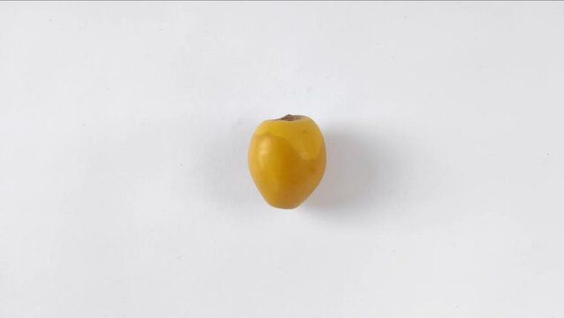 A fresh young dates or rutob dates or ruthob dates on a white background.