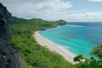 A beautiful beach with a rocky cliff in the background. The ocean is calm and blue. The beach is full of trees and bushes