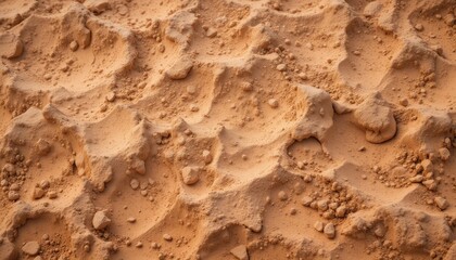 Obraz premium Rugged Texture of Light Orange Dusty Earth Surface Close-Up Detail of Dry, Grainy Soil with Small Rocks