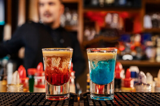 Close up of two monkey brain shot cocktails on bar counter in a bar.