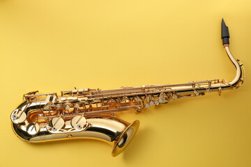 Jazz. One saxophone on yellow background, top view. Space for text