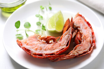 Delicious boiled lobster served on white table, closeup
