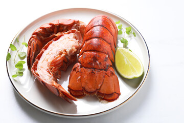 Delicious tails of boiled lobsters served on white table, closeup