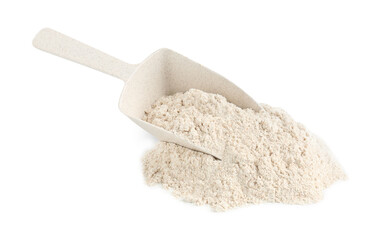 Pile of brown rice flour and scoop isolated on white