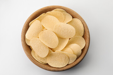 Tasty potato chips in bowl on white background, top view