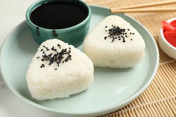 Rice balls (onigiri) served on table, closeup. Traditional Japanese dish