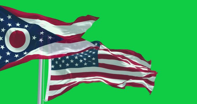 Ohio and national US flags waving in the wind isolated on green background