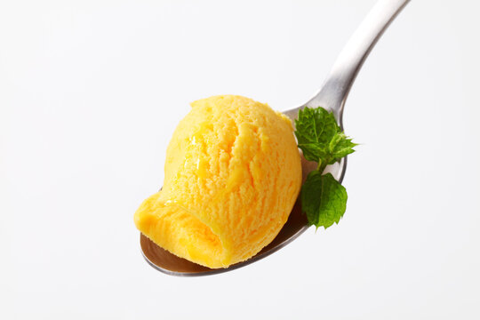 Yellow ice cream on spoon