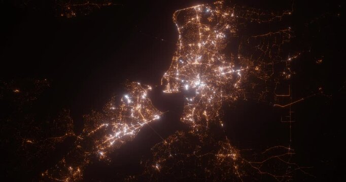 Norfolk (Virginia, USA) top view at night. Aerial view on modern city with lights. Camera is flying above the city, moving backward. Vertical video. The north is on the left side